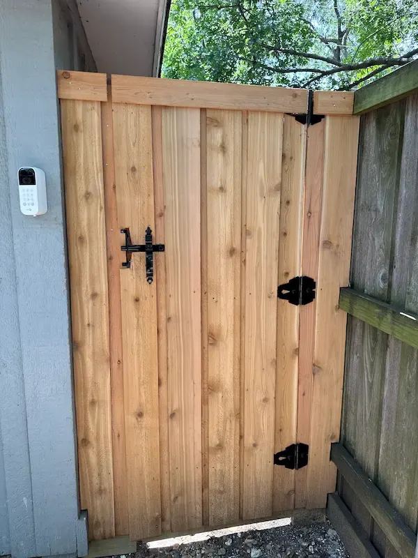Cedar pedestrian gate with a black strap hinge, latch and keypad lock